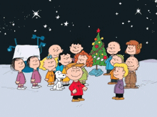 a group of peanuts characters are gathered around a christmas tree