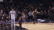 a basketball player with the number 28 on his jersey stands on the court
