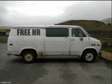 a white van is parked in a parking lot with the words `` free hr '' written on the side .