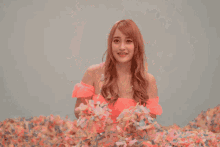 a woman in a pink top is throwing confetti in the air