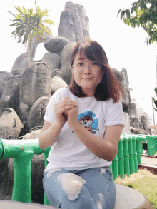 a woman wearing a white t-shirt with a picture of a cat on it