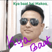 a man wearing sunglasses and a white shirt with the words kya baat hai makoo written on it