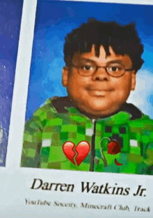 a picture of a boy wearing glasses and a green jacket with a broken heart on it .