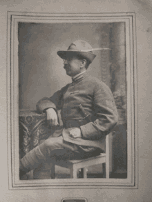 a black and white photo of a man in military uniform