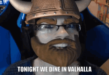 a man with a beard and glasses is wearing a viking helmet and says tonight we dine in valhalla