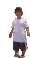 a boy wearing a white shirt and blue shorts is walking on a white background