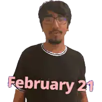 a man wearing glasses and a black shirt that says february 21 on it