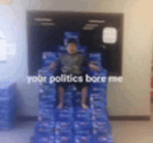 a child is sitting on a pile of pepsi boxes .