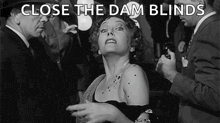 a black and white photo of a woman with the words close the dam blinds written above her