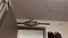 a belt is hanging from the ceiling in a room with hats hanging on the wall