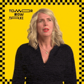 a woman is standing in front of a yellow and black checkered background that says tomorrow row taxi