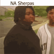 a man standing next to another man with the words na sherpas on the bottom