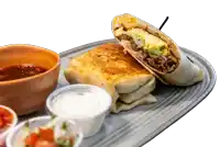 a burrito is cut in half on a plate next to a bowl of chili