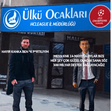 two men standing in front of a sign that says ulku ocaklari hcleague il müdürlüğü