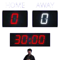 a scoreboard that says home and away with a man standing in front of it