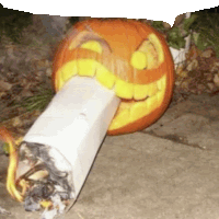 a pumpkin carved to look like a cigarette with a smile on its face