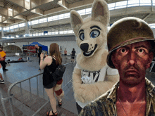 a man in a military helmet stands next to a woman in a furry dog costume