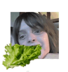 a woman is eating a leaf of lettuce next to a leaf of lettuce