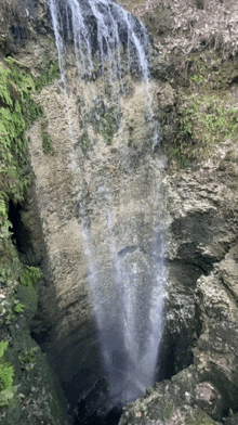 a waterfall in the middle of a rocky cliff