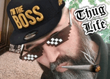 a man with a beard wearing sunglasses and a hat that says i 'm the boss