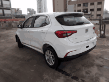 a white car with the word fiat on the back is parked in a parking lot