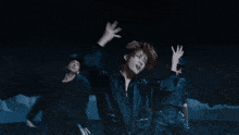 a group of people are dancing in the dark