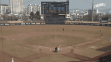 a baseball game is being played in front of a scoreboard that says tigers