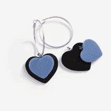 a pair of heart shaped earrings and a hoop earring