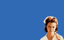 a woman in a white nurse 's uniform is holding a knife