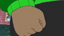 a close up of a cartoon character 's fist with a green sweater on