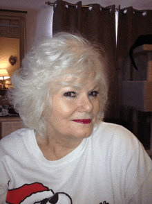 a woman wearing a white shirt with a santa hat on