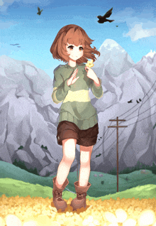 a girl in a sweater and shorts stands in front of a mountain