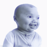 a baby in a white shirt is smiling and looking at the camera
