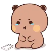 a cartoon bear is crying while sitting next to a phone .