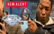 a man is holding a magnifying glass in front of a diamond .