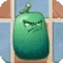 a green cartoon character with a very angry face is sitting on a brick wall .