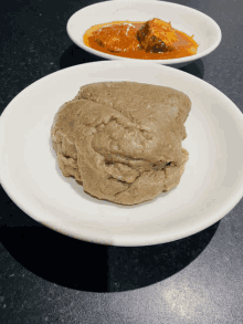 a white plate with a piece of food on it next to a bowl of food