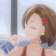 a girl is drinking a bottle of pocari sweat .