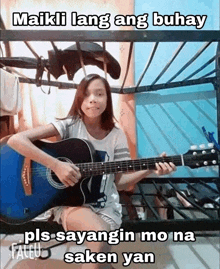 a young girl is playing a guitar in a bunk bed .