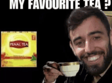 a man with a beard is drinking a cup of tea next to a box of penal tea .