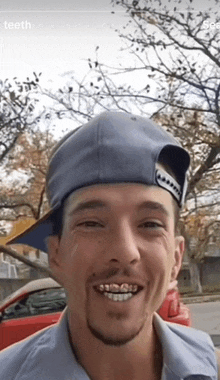 a man wearing a hat with the word teeth on the bottom