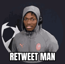 a man wearing headphones and a grey hoodie says " retweet man "