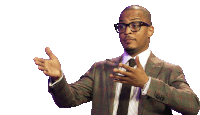 a man wearing glasses and a suit is giving a presentation