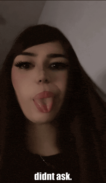a girl sticking her tongue out with the words didnt ask below her