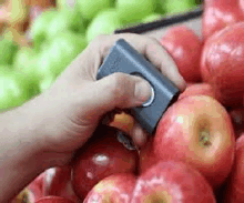 a person is cutting an apple with a knife .