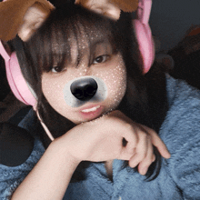 a girl wearing pink headphones with a dog face on her face