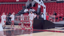 a group of girls are dancing on a basketball court and one of them is wearing a t-shirt that says texas tech