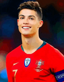 a young man wearing a red soccer jersey with the number 7 on it