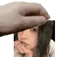 a hand is covering a woman 's face in a pixelated photo .