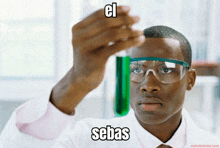 a man wearing glasses holds a test tube with a green liquid in it and says el sebas on the bottom